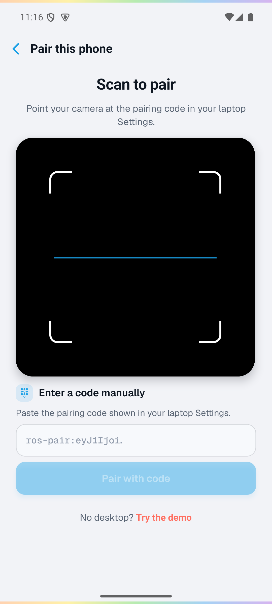 The Companion hub on a laptop showing a pairing QR code, next to the phone's camera view framing that code during a scan.